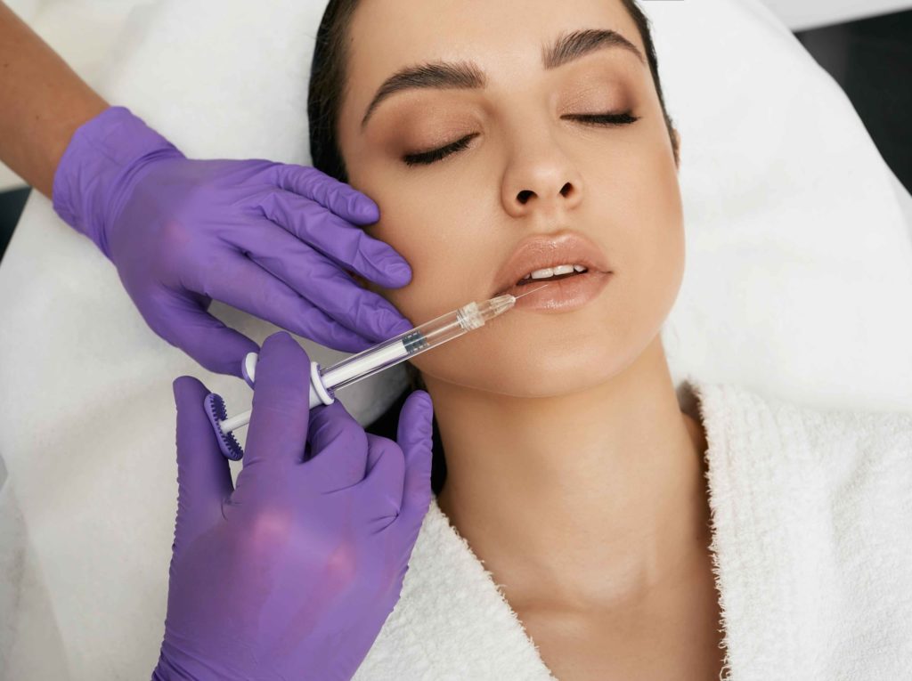 A Female getting injection on lips | Dermal Fillers | Rejuve Wellness in The Woodlands and Montgomery, TX